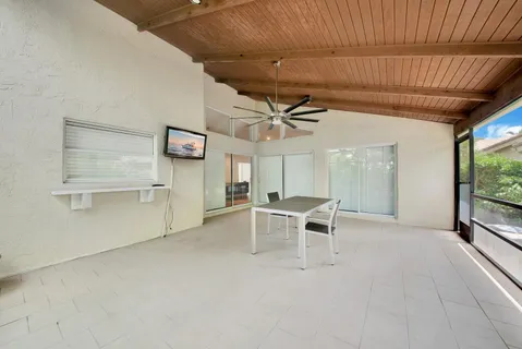 a view of a livingroom with furniture and a ceiling fan