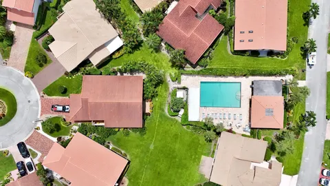 an aerial view of house with yard swimming pool and outdoor seating