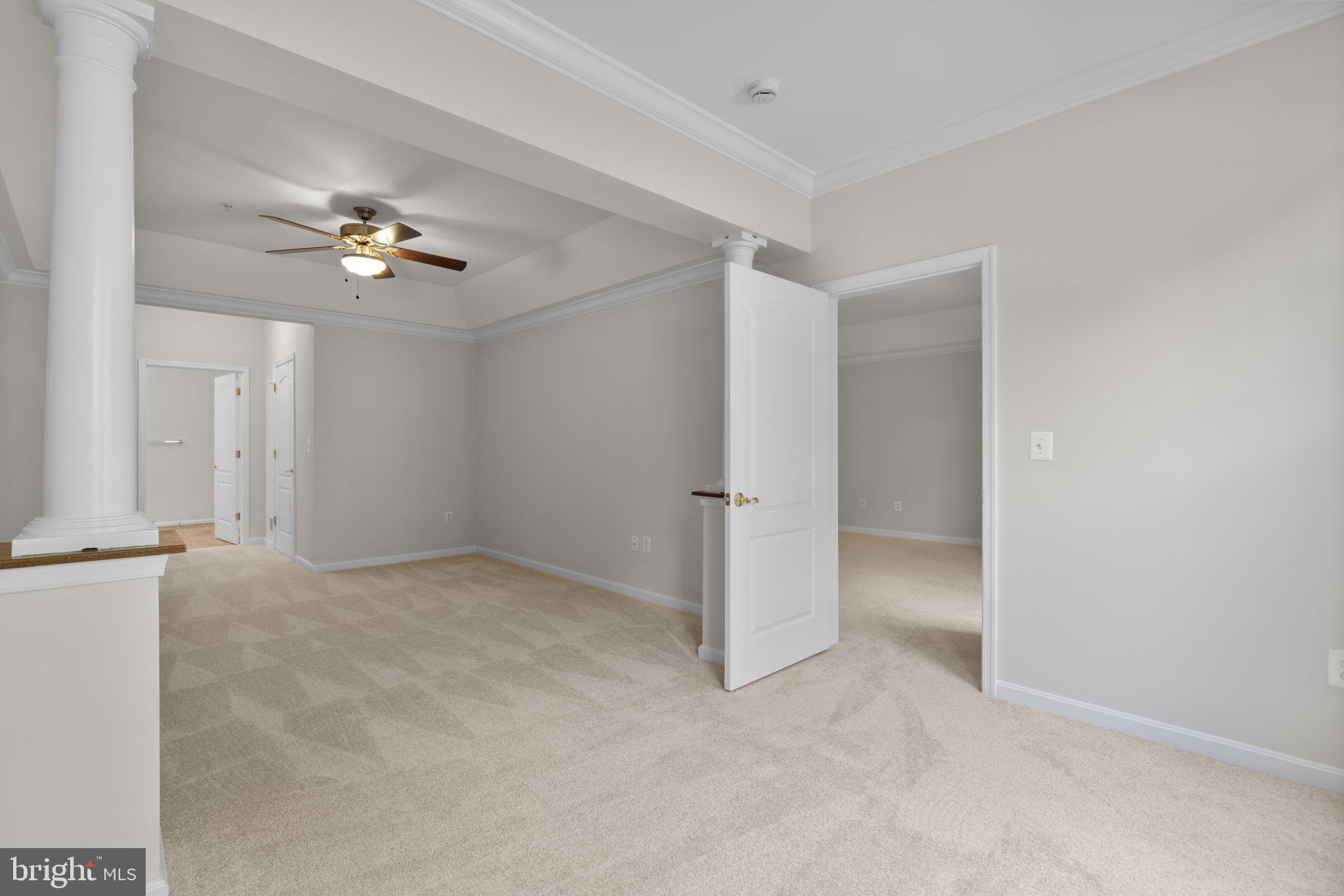 7315 Maplecrest Road, Unit 104 Elkridge, MD 21075 - Photo 30 of 58 a view of an empty room with a ceiling fan