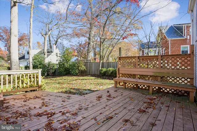 a view of a wooden bench on the side of a road