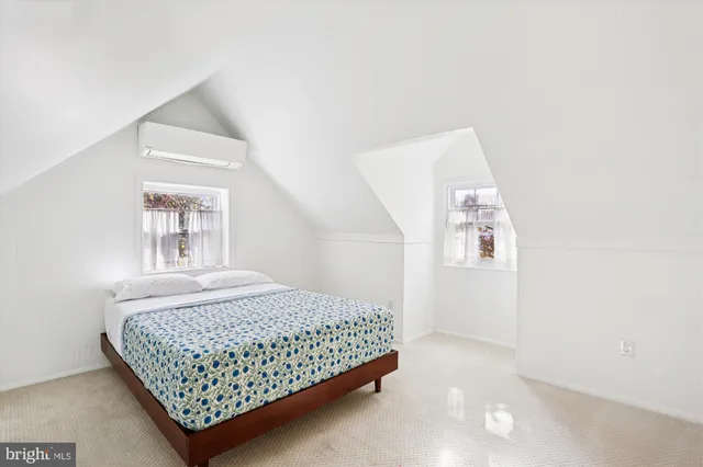 a bedroom with a bed and a night stand