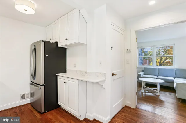 a view of kitchen with furniture and wooden floor