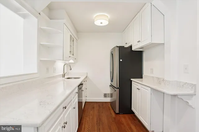 a kitchen with a sink a refrigerator and a stove