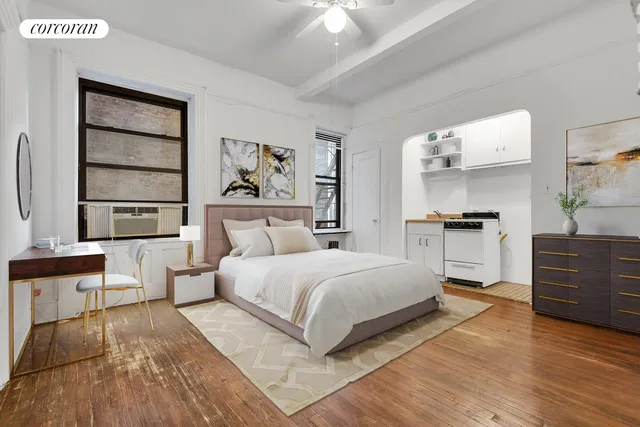 a bedroom with a large bed and a window