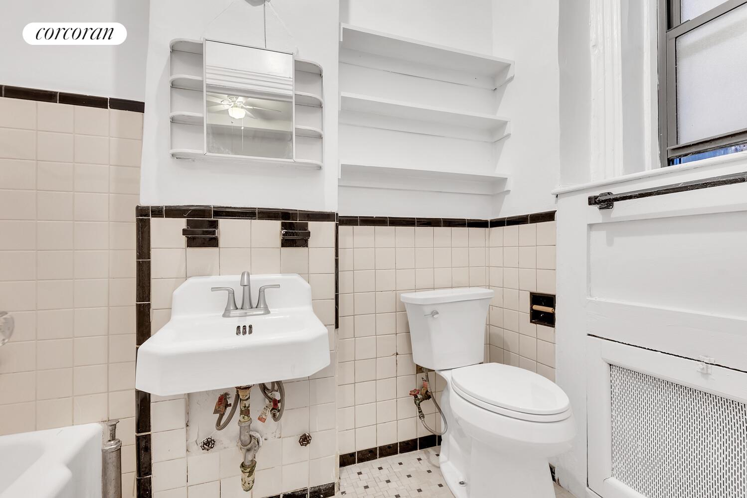 615 West 113th Street, Unit 2 Manhattan, NY 10025 - Photo 3 of 7 a bathroom with a sink a toilet and shower