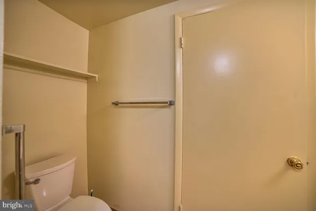 a white toilet sitting next to a shower