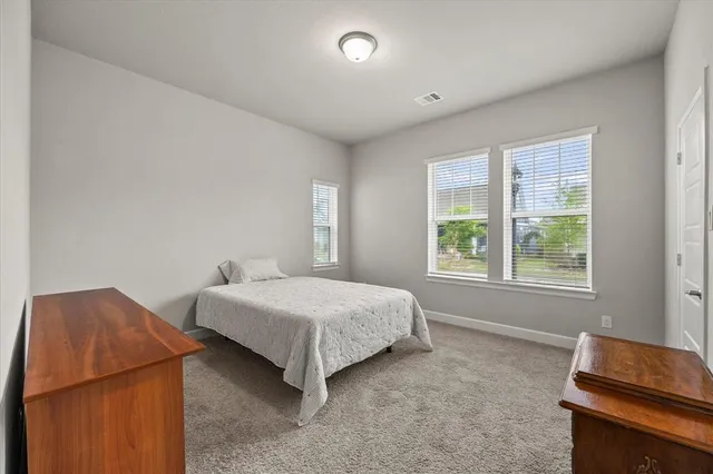 a spacious bathroom with a double vanity sink a mirror and a shower