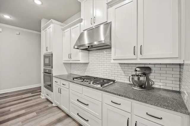 a open kitchen with stainless steel appliances kitchen island granite countertop a sink and refrigerator
