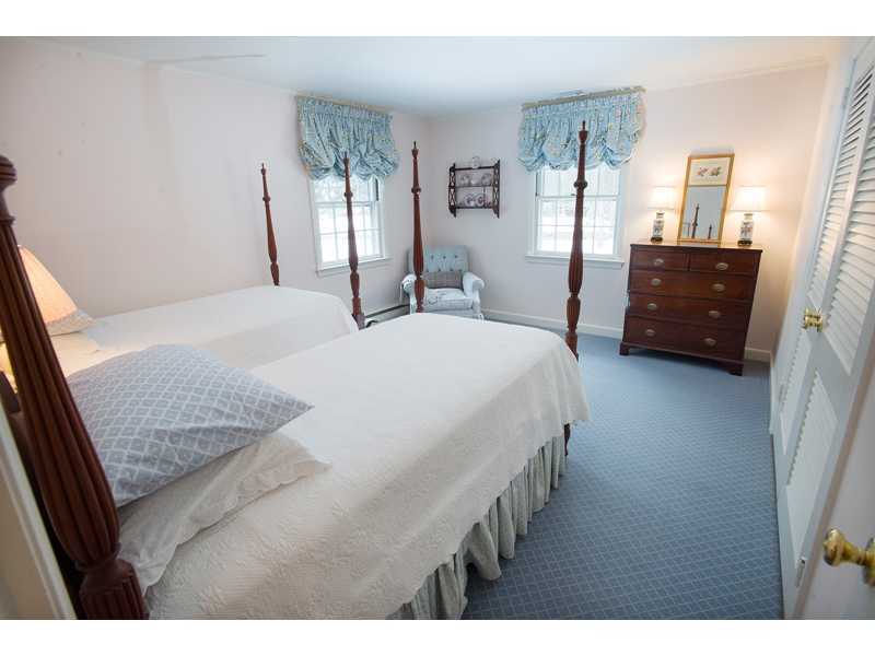 201 Michigan Road New Canaan, CT 06840 - Photo 18 of 25 a living room with a bed furniture and a flat tv screen