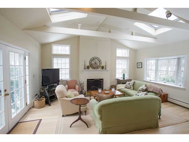201 Michigan Road New Canaan, CT 06840 - Photo 6 of 25 a living room with furniture a fireplace and a large window