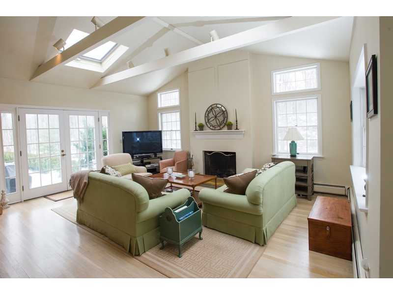 201 Michigan Road New Canaan, CT 06840 - Photo 7 of 25 a living room with furniture a large window and a fireplace