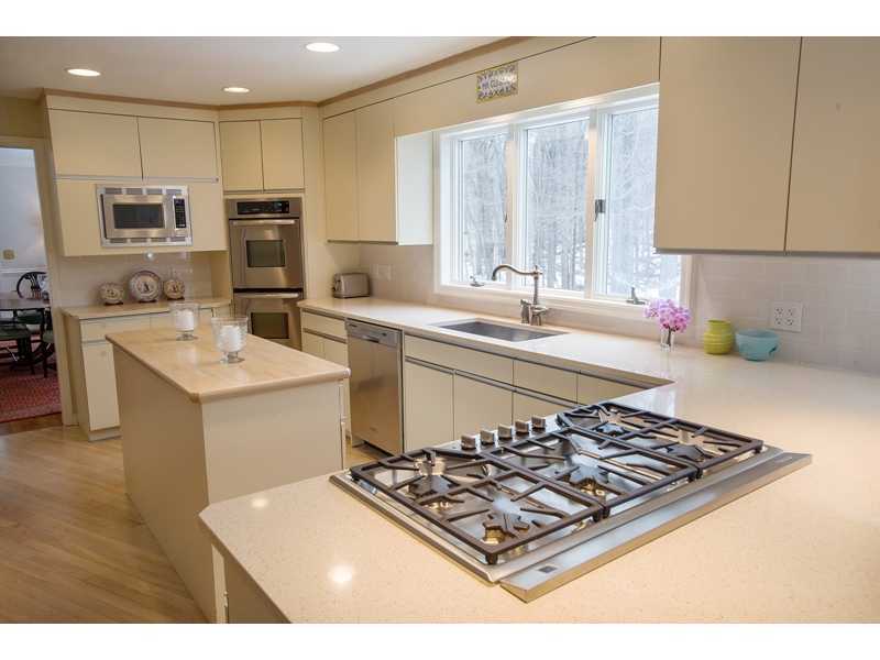 201 Michigan Road New Canaan, CT 06840 - Photo 9 of 25 a kitchen with a stove a sink and a refrigerator