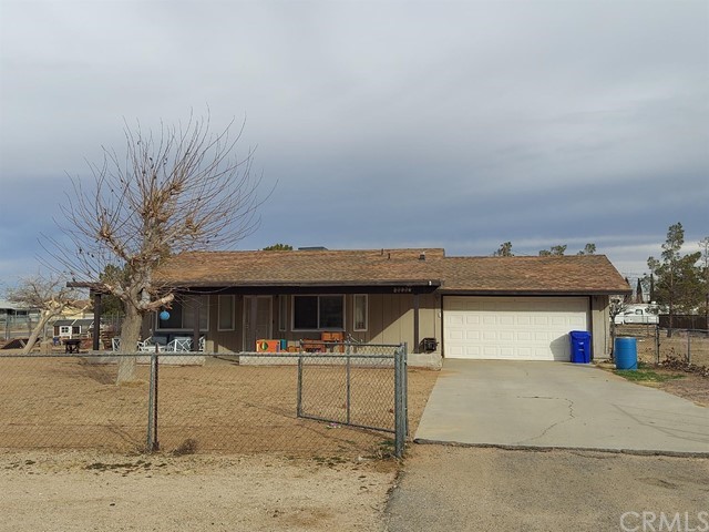 21516 Tussing Ranch Road Apple Valley, CA 92308 - Photo 1 of 1 a front view of a building with parking