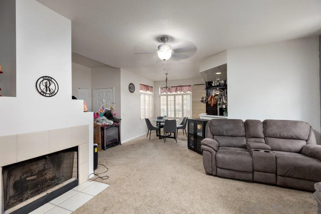 1352 Serena Circle, Unit 2 Chula Vista, CA 91910 - Photo 11 of 22 a living room with furniture and a fireplace
