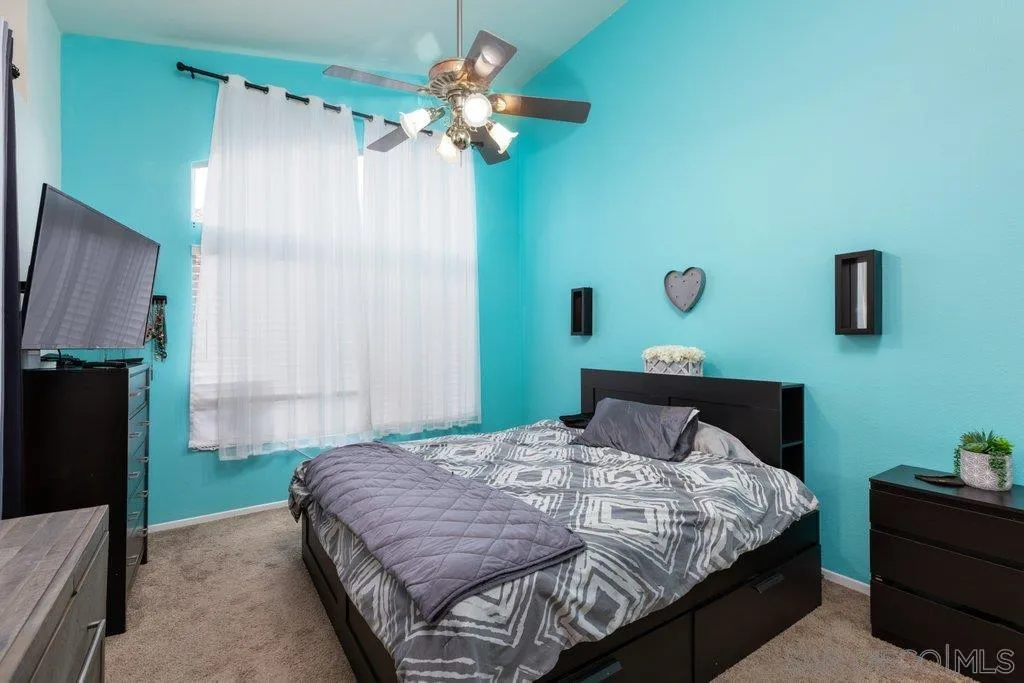 1352 Serena Circle, Unit 2 Chula Vista, CA 91910 - Photo 15 of 22 a bedroom with a bed dresser and a window