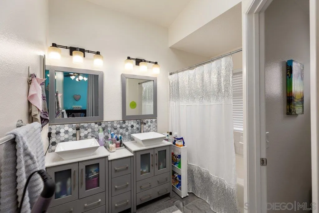 1352 Serena Circle, Unit 2 Chula Vista, CA 91910 - Photo 18 of 22 a bathroom with a double vanity sink mirror and shower