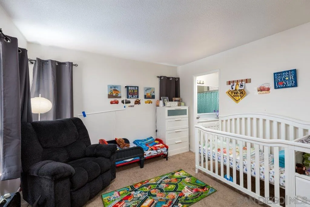 1352 Serena Circle, Unit 2 Chula Vista, CA 91910 - Photo 19 of 22 a bedroom with furniture and a rug