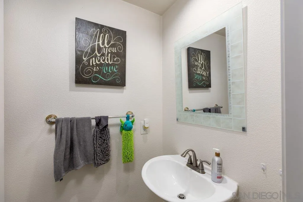 1352 Serena Circle, Unit 2 Chula Vista, CA 91910 - Photo 22 of 22 a bathroom with a sink and a mirror