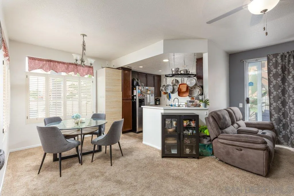 1352 Serena Circle, Unit 2 Chula Vista, CA 91910 - Photo 3 of 22 a living room with furniture a fireplace and a chandelier
