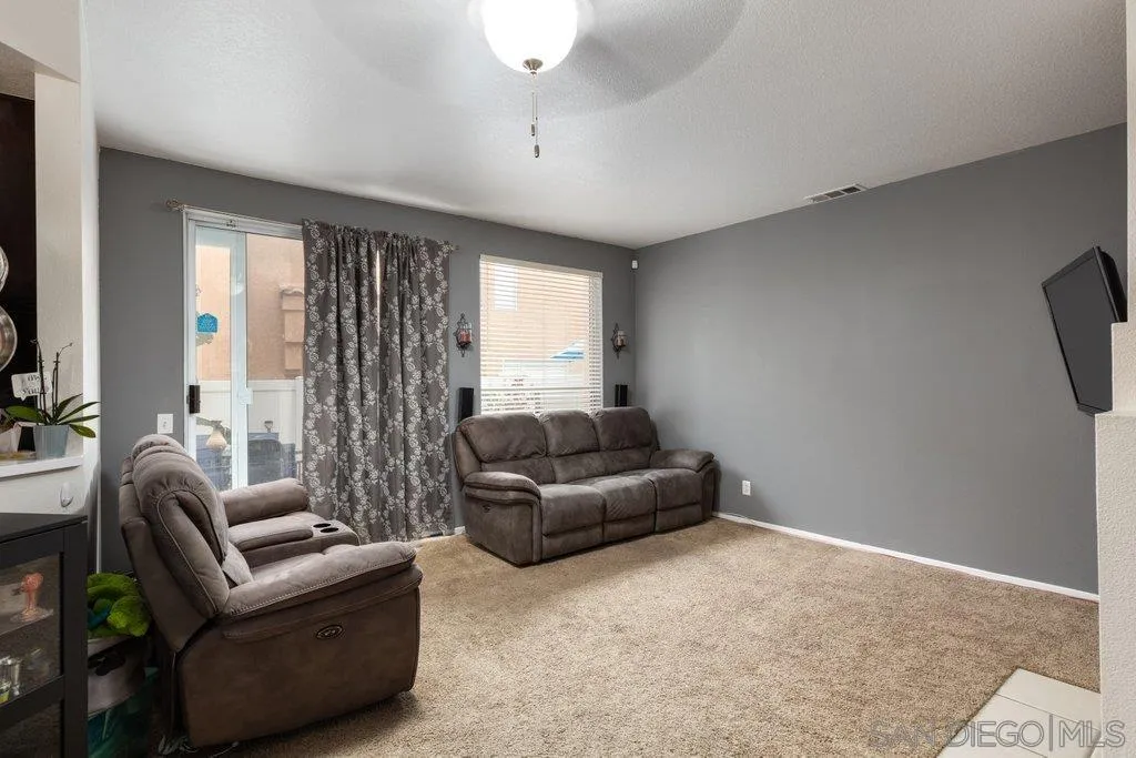 1352 Serena Circle, Unit 2 Chula Vista, CA 91910 - Photo 6 of 22 a living room with furniture and a large window
