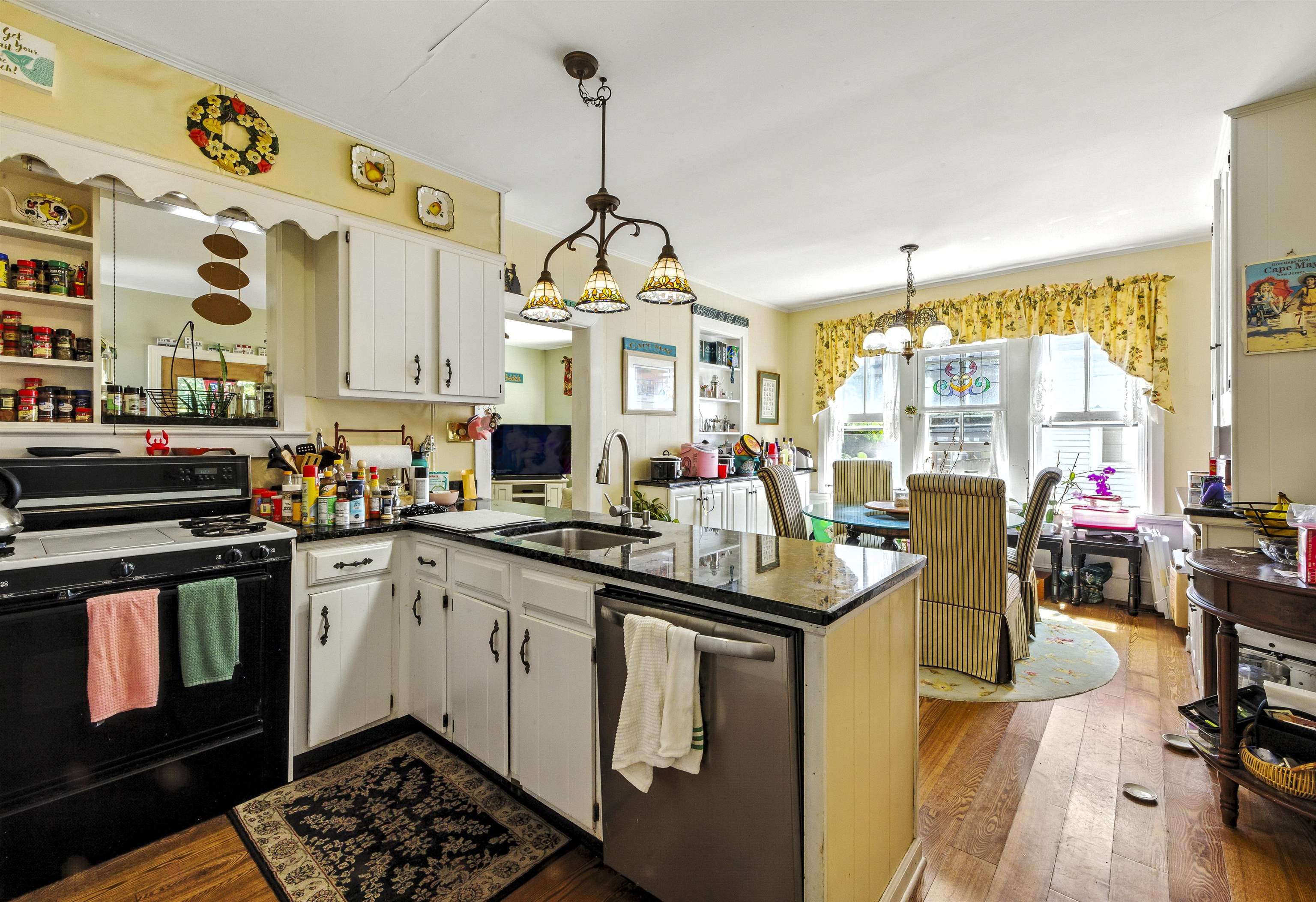 35 1st Cape May, NJ 08204 - Photo 12 of 49 a kitchen with stainless steel appliances granite countertop a stove and a view of living room