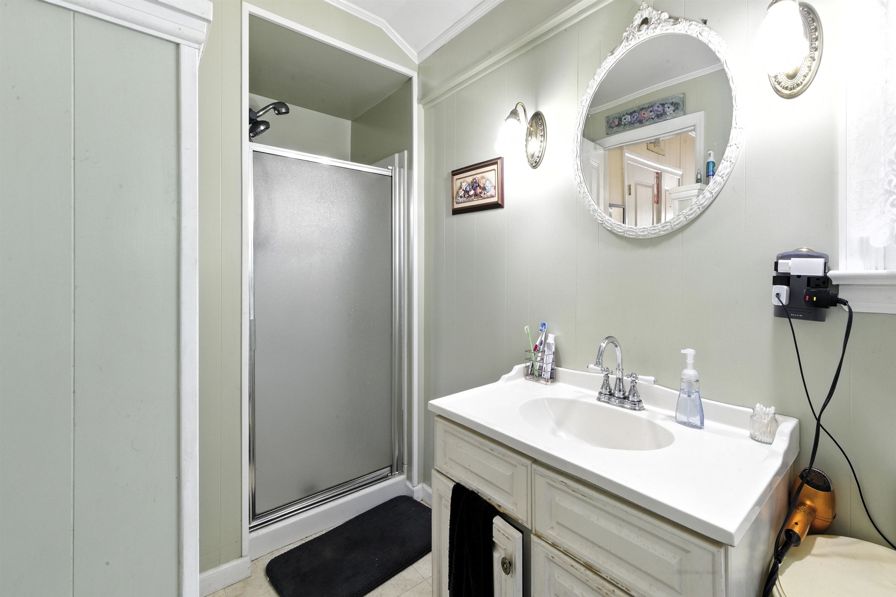 35 1st Cape May, NJ 08204 - Photo 20 of 49 a bathroom with a sink and a mirror