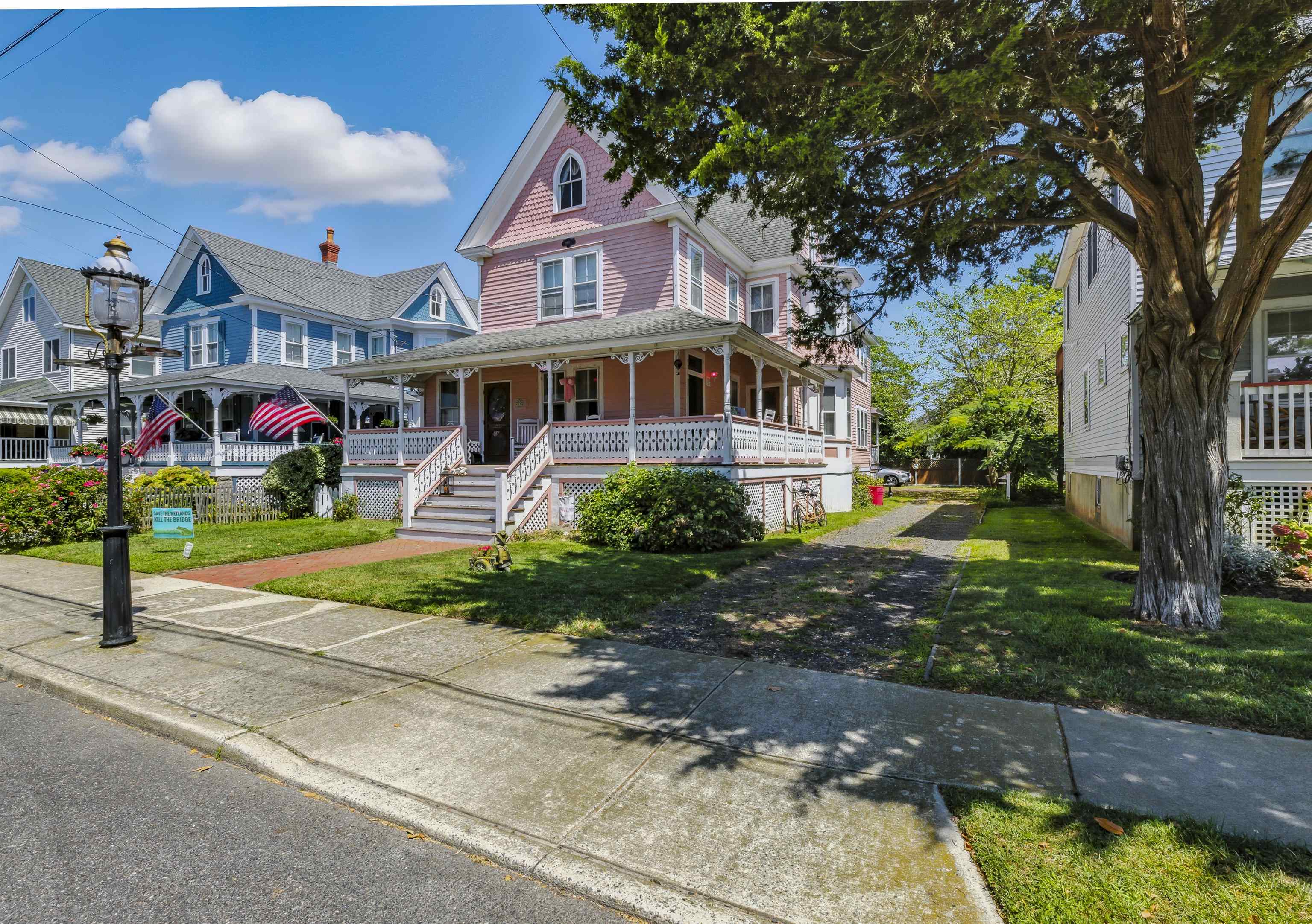 35 1st Cape May, NJ 08204 - Photo 3 of 49 a front view of a house with a yard and potted plants