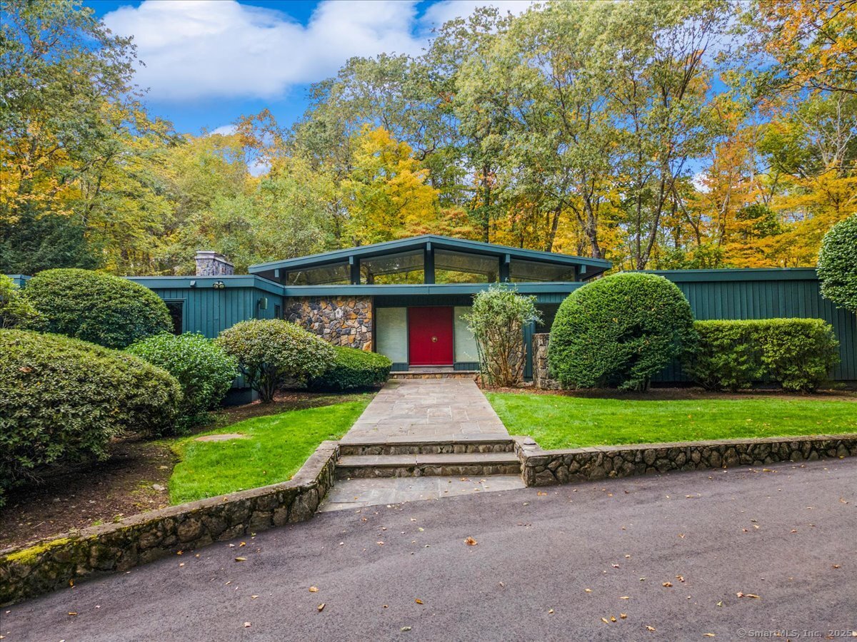 100 East Common Road Easton, CT 06612 - Photo 1 of 25 a front view of a house with a yard and garage