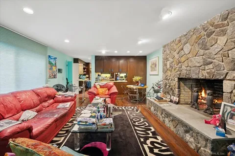 a living room with furniture a red couch and a fireplace