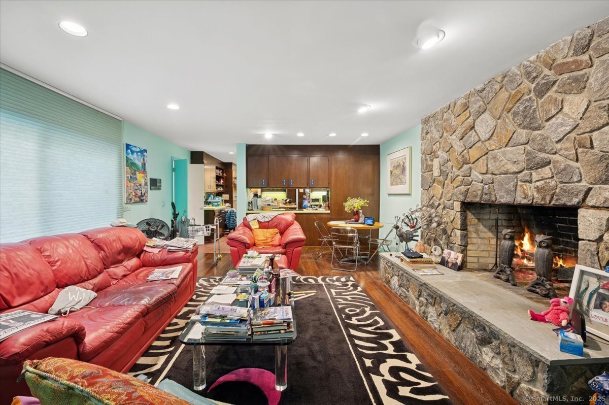 100 East Common Road Easton, CT 06612 - Photo 16 of 25 a living room with furniture a red couch and a fireplace