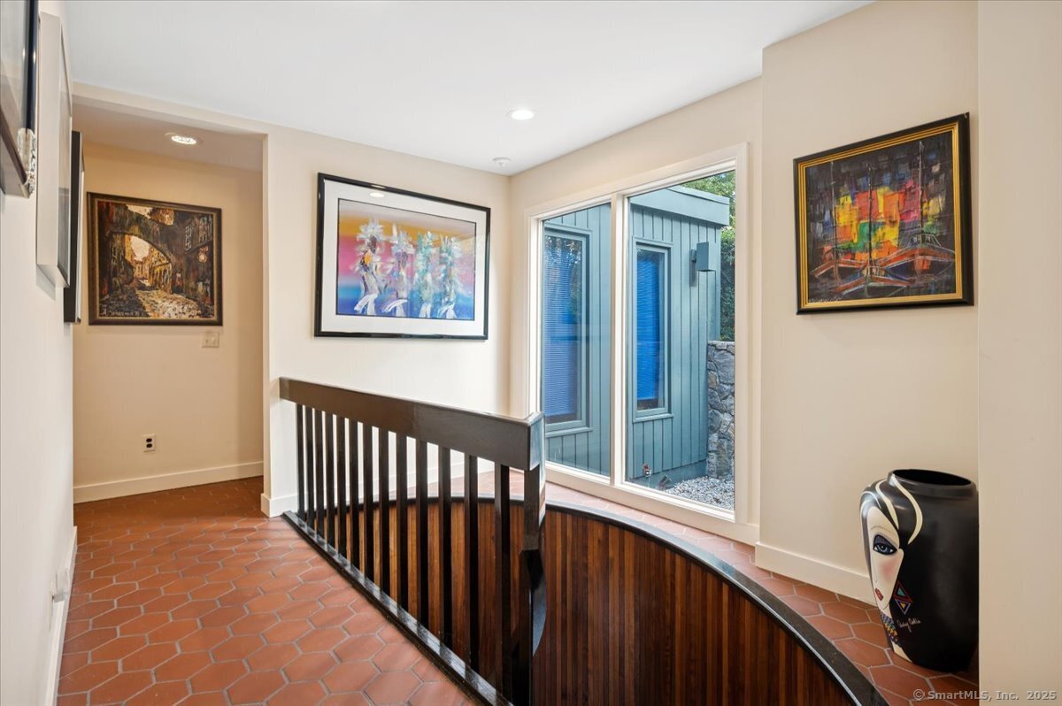100 East Common Road Easton, CT 06612 - Photo 17 of 25 a view of a hallway with wooden floor and stairs