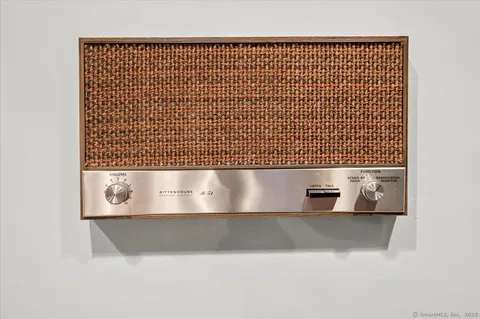 a blue painted wall with a table and chairs