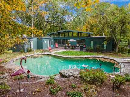 an aerial view of a house with swimming pool garden and patio