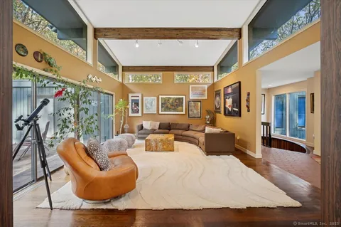 a bedroom with furniture and a large window