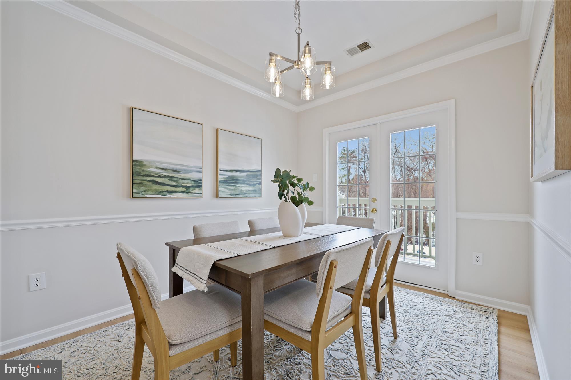 106 Booth Street, Unit 34 Gaithersburg, MD 20878 - Photo 13 of 46 a dining room with furniture a rug and a chandelier