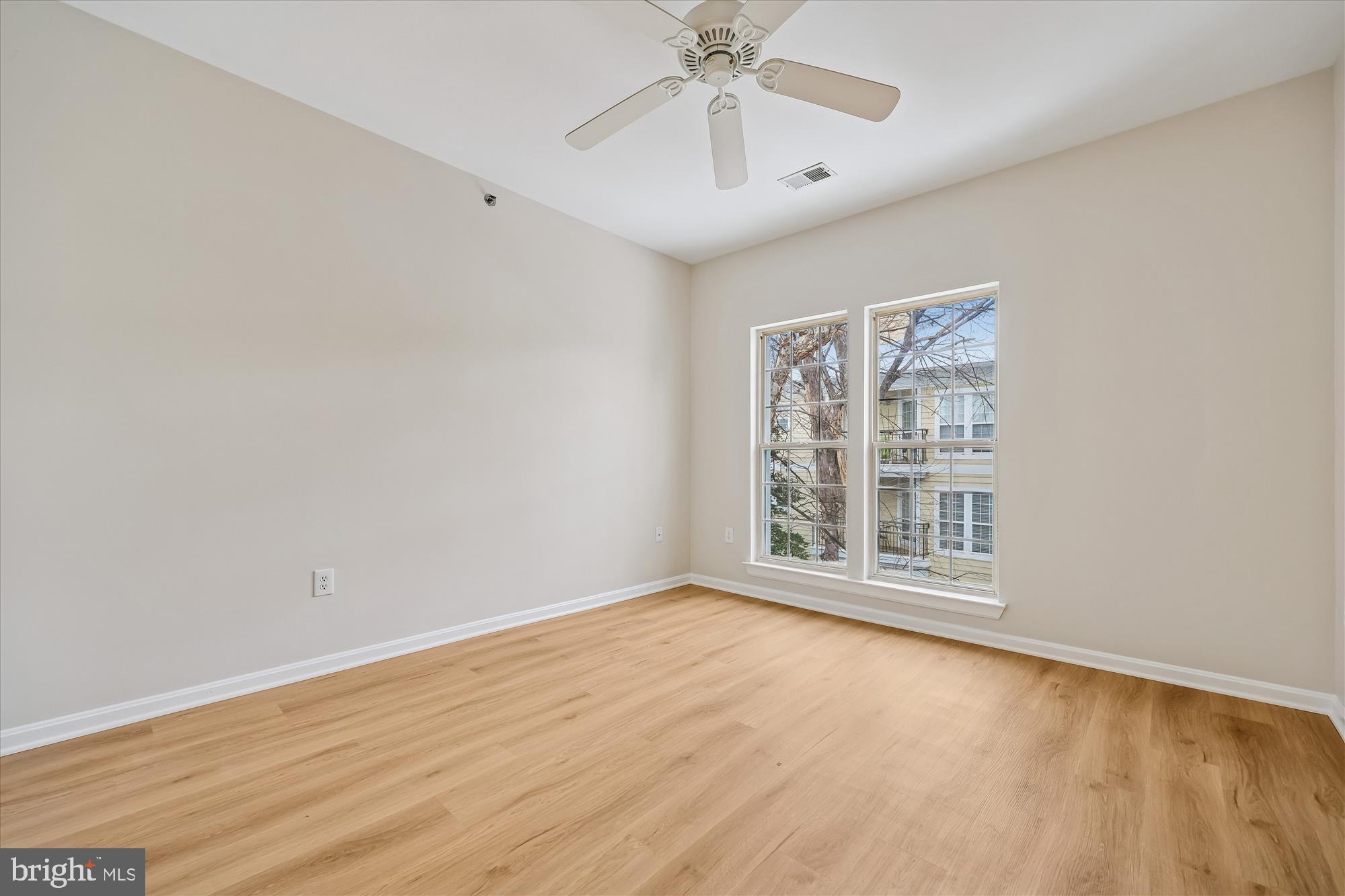 106 Booth Street, Unit 34 Gaithersburg, MD 20878 - Photo 20 of 46 a view of an empty room with a window and wooden floor