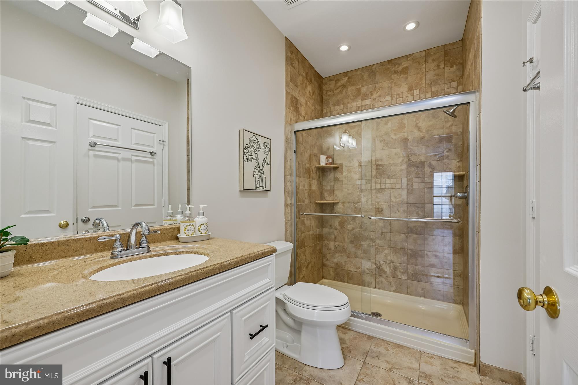 106 Booth Street, Unit 34 Gaithersburg, MD 20878 - Photo 22 of 46 a bathroom with a granite countertop sink a toilet a mirror and shower