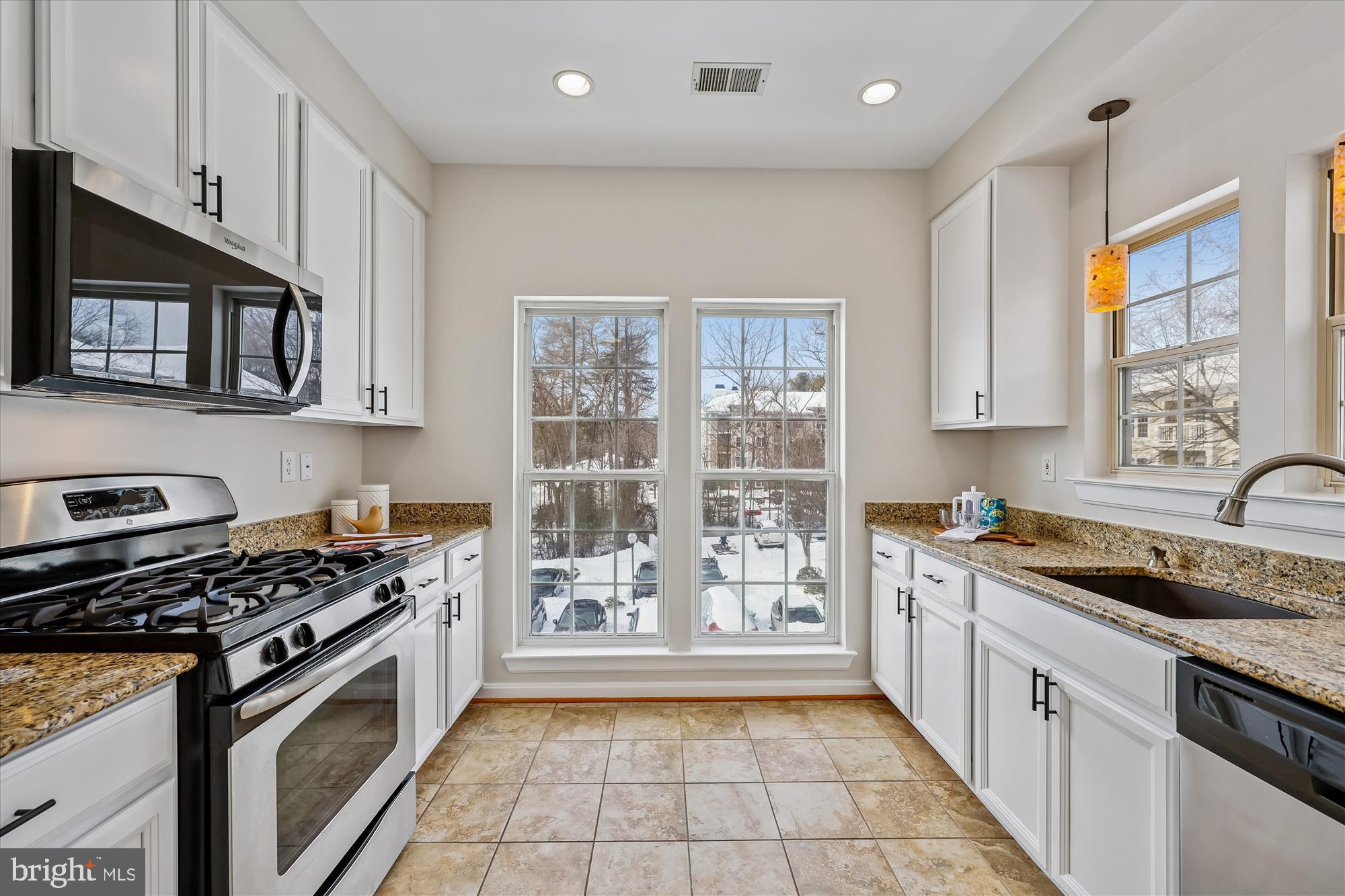 106 Booth Street, Unit 34 Gaithersburg, MD 20878 - Photo 7 of 46 a kitchen with a stove a sink and a microwave