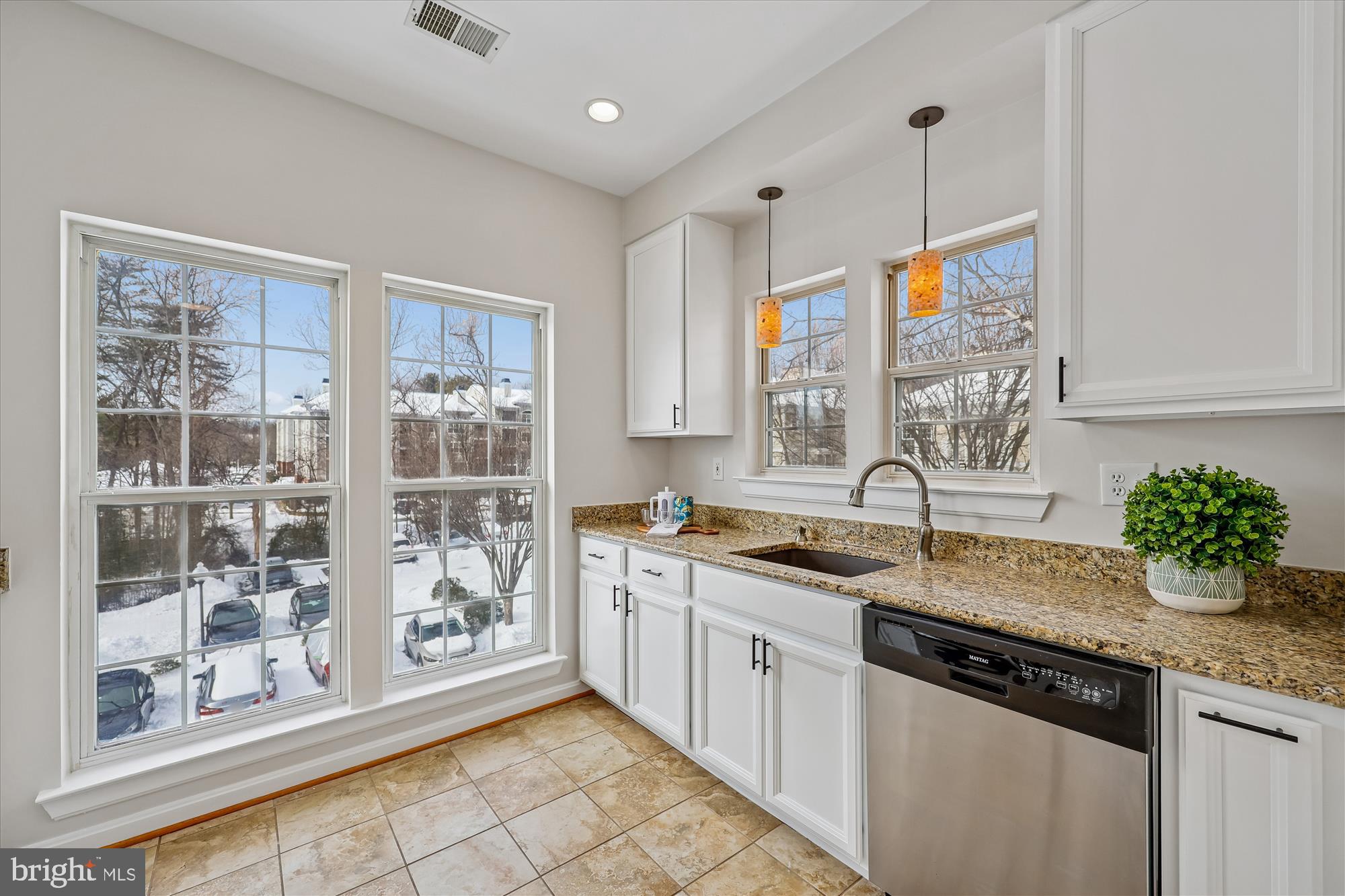 106 Booth Street, Unit 34 Gaithersburg, MD 20878 - Photo 9 of 46 a kitchen with granite countertop a sink stainless steel appliances and cabinets