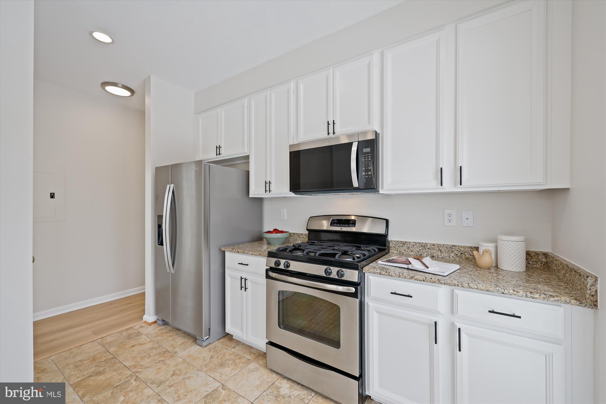 106 Booth Street, Unit 34 Gaithersburg, MD 20878 - Photo 10 of 46 a kitchen with cabinets stainless steel appliances and a counter space