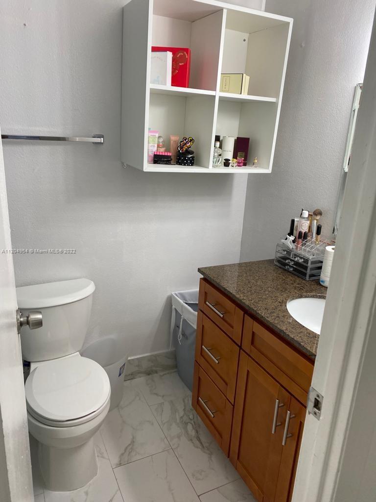 17901 Northwest 68th Avenue, Unit T207 Hialeah, FL 33015 - Photo 13 of 19 a bathroom with a sink and a toilet