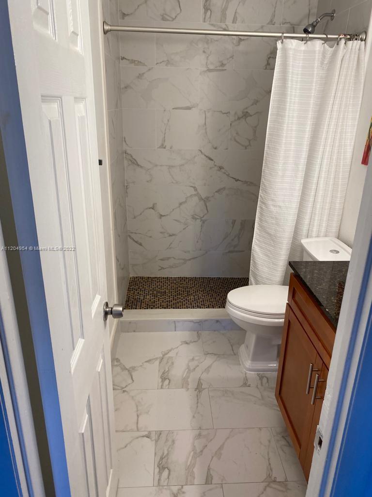 17901 Northwest 68th Avenue, Unit T207 Hialeah, FL 33015 - Photo 14 of 19 a bathroom with a sink and a toilet