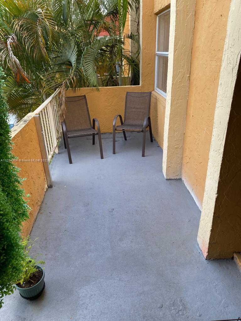 17901 Northwest 68th Avenue, Unit T207 Hialeah, FL 33015 - Photo 18 of 19 a view of balcony and patio