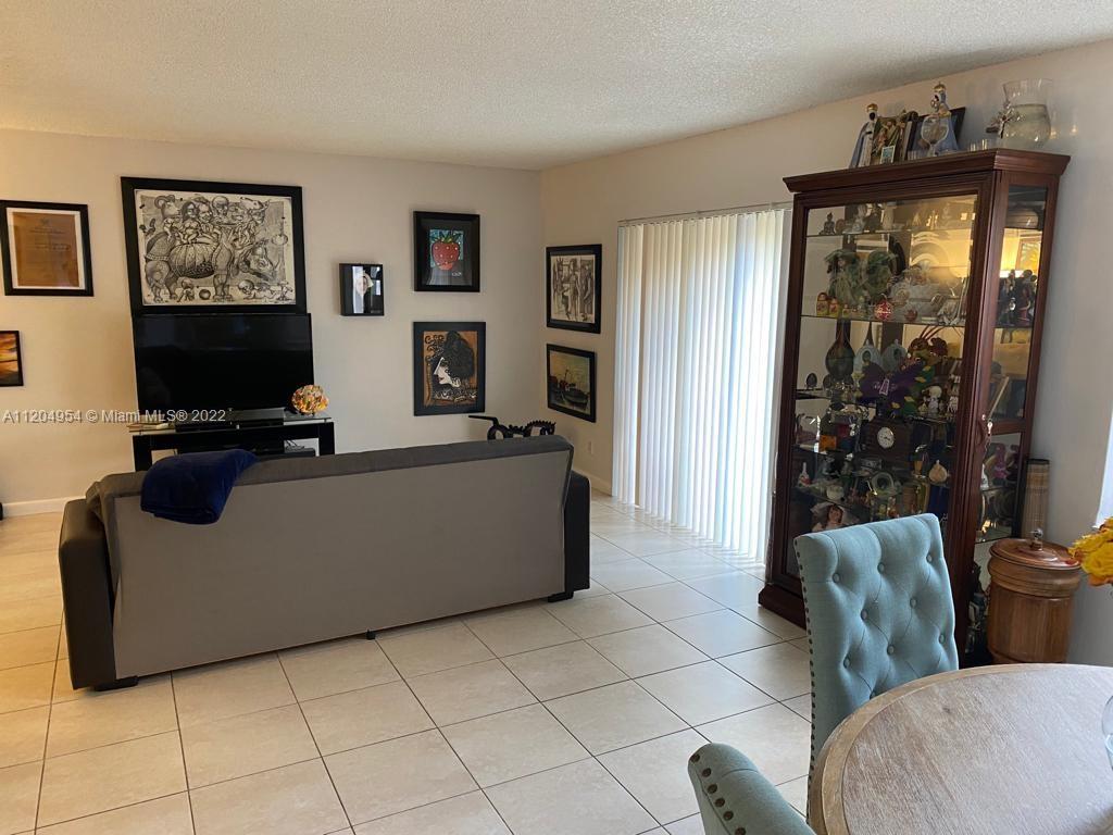 17901 Northwest 68th Avenue, Unit T207 Hialeah, FL 33015 - Photo 3 of 19 a living room with furniture and a flat screen tv