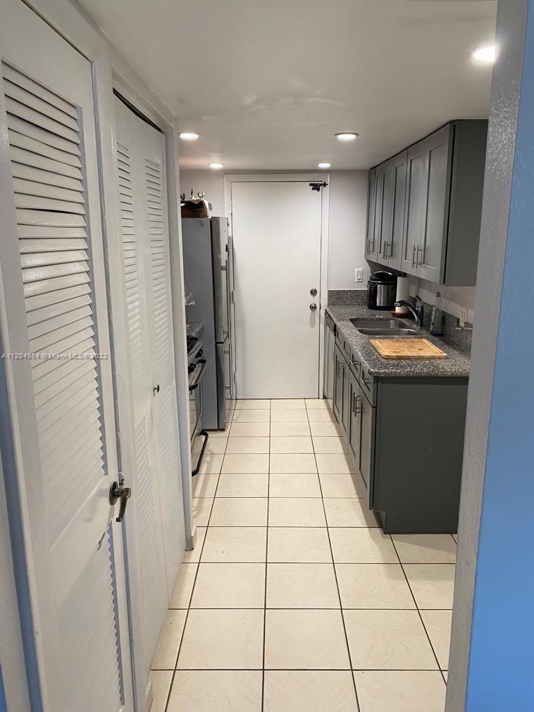 17901 Northwest 68th Avenue, Unit T207 Hialeah, FL 33015 - Photo 7 of 19 a kitchen with stainless steel appliances granite countertop a refrigerator and a stove
