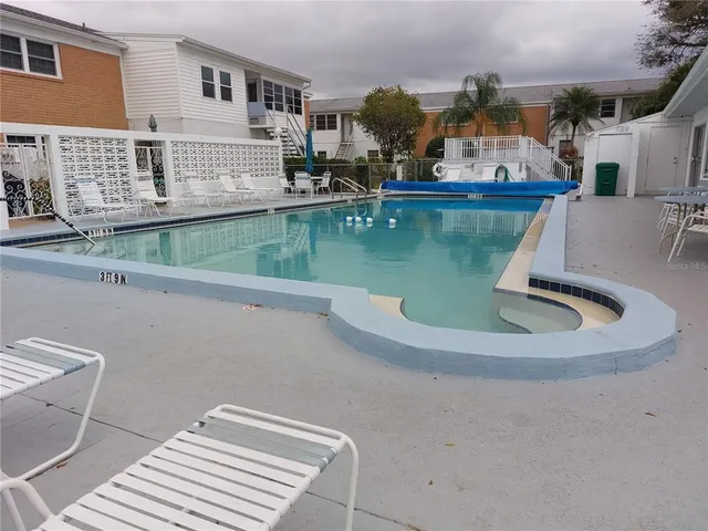 a view of a house with pool table and chairs