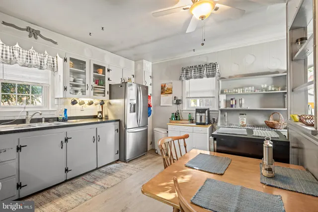 a kitchen with stainless steel appliances kitchen island granite countertop a refrigerator and a stove