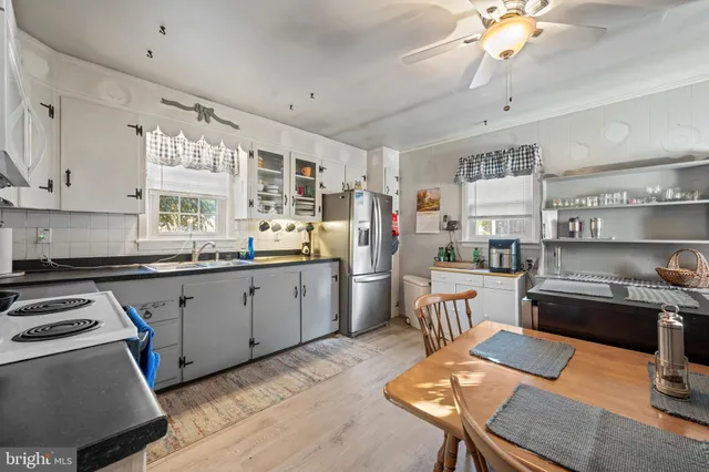 a kitchen with stainless steel appliances kitchen island granite countertop a sink and cabinets