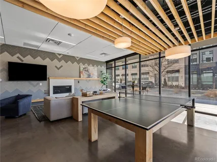 a kitchen with a table chairs microwave and furniture