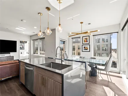 a kitchen with a sink a counter and chairs